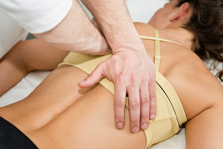 Person gently stretching their neck in a naturally lit living room with a relaxed expression.